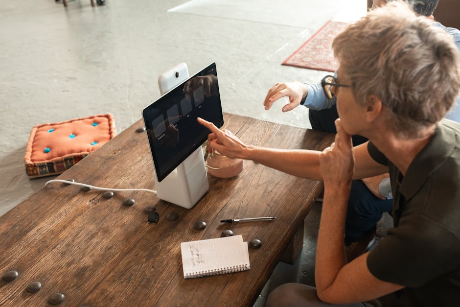 Elderly woman engaged in online learning via a digital tablet indoors.