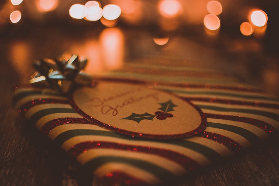 Close-up of a Christmas gift with lights and festive wrapping, creating a warm holiday atmosphere.